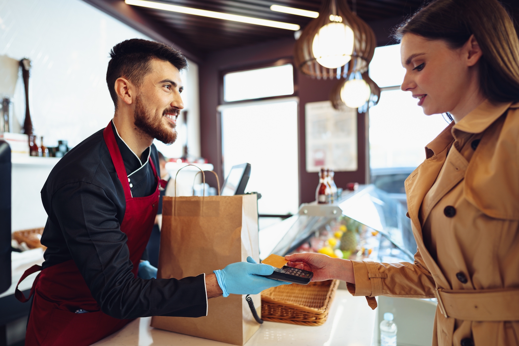 Young,Woman,Paying,Credit,Card,For,Purchases,In,Grocery,Store.